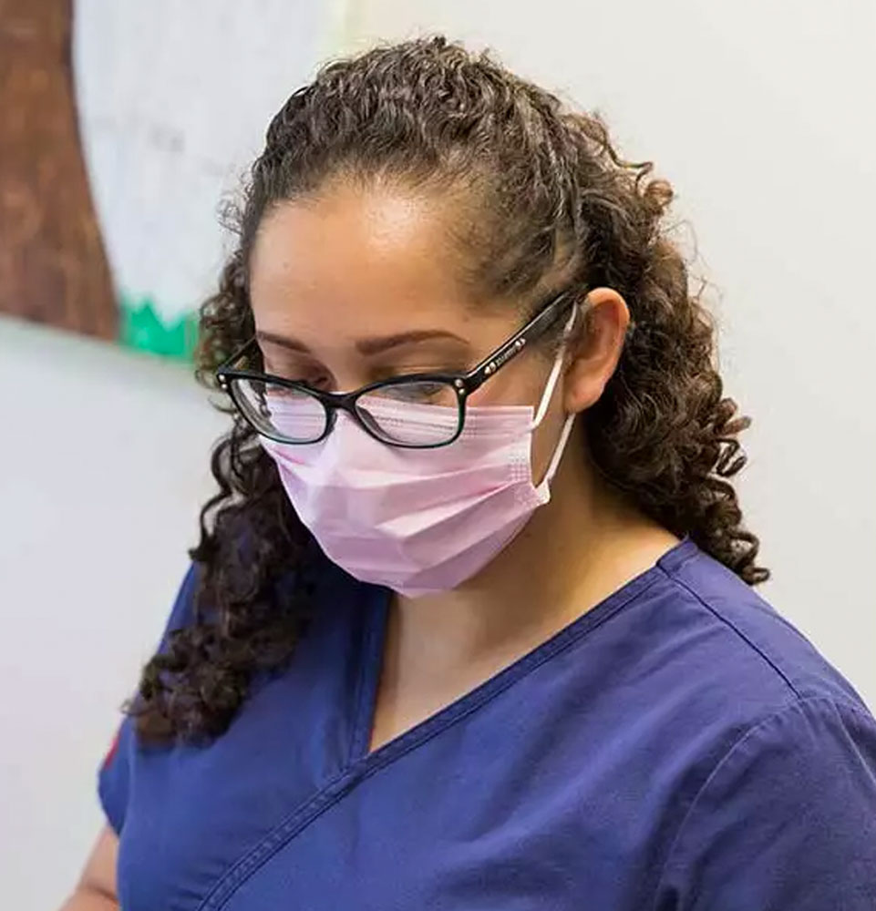 assistant with dr ferrier helping patient